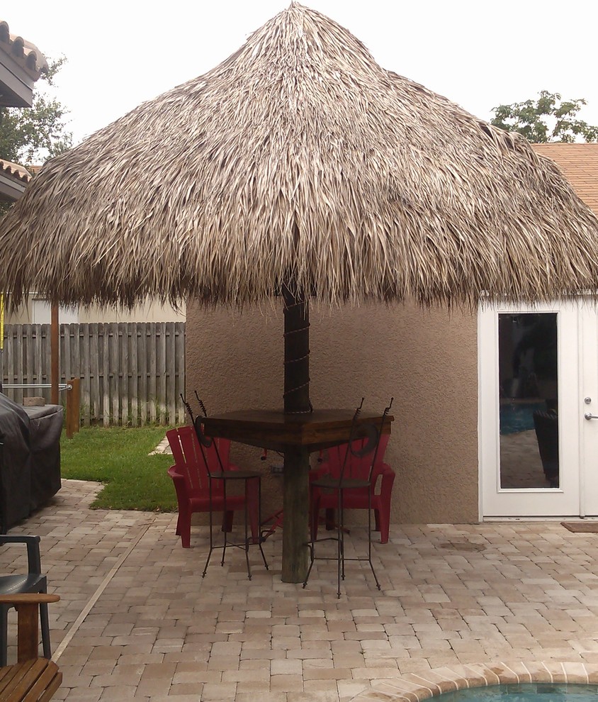 Example of an island style patio design in Tampa