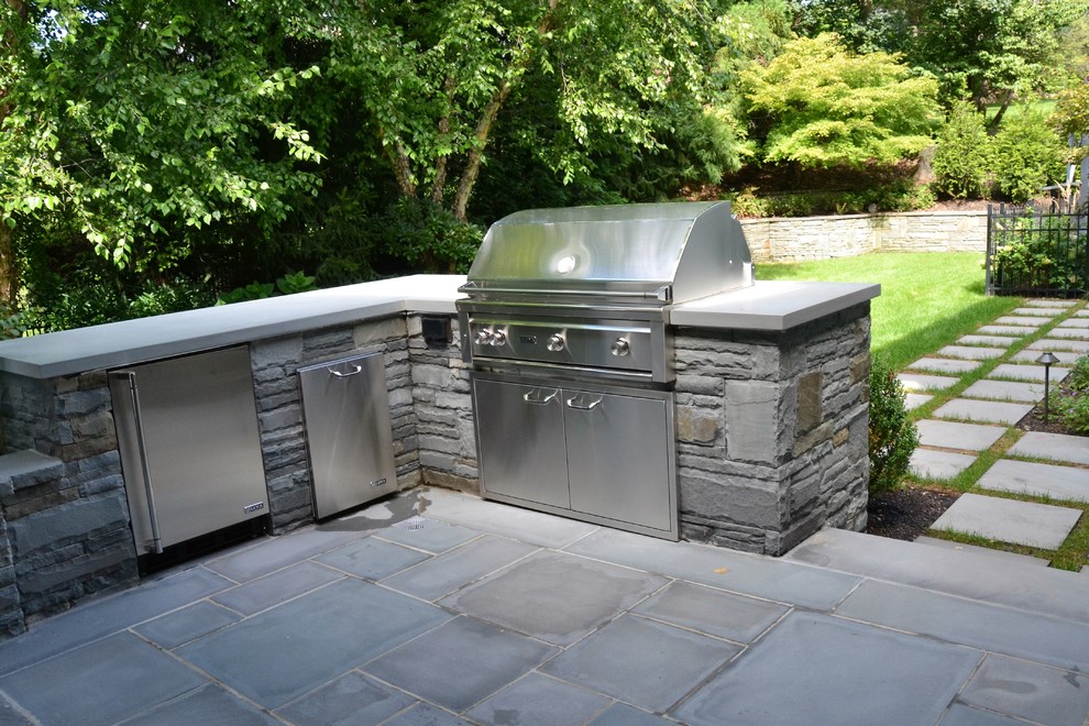 Inspiration for a mid-sized modern backyard concrete paver patio kitchen remodel in New York with no cover