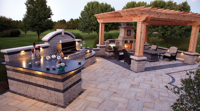 Inspiration for a large contemporary backyard concrete paver patio kitchen remodel in Other with a pergola