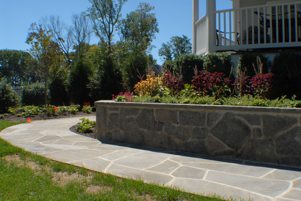Mid-sized tuscan side yard stone patio photo in New York with no cover