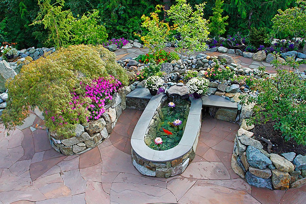 Patio - mid-sized contemporary backyard stone patio idea in Seattle with a fire pit and no cover