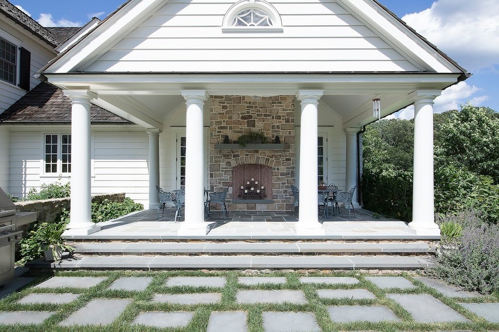 Mid-sized elegant backyard concrete paver patio photo in New York with a fire pit and a gazebo
