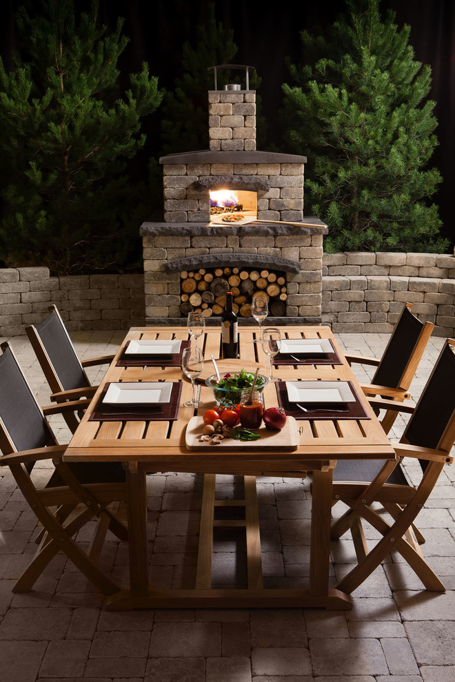 Large elegant backyard concrete paver patio kitchen photo in Other with no cover