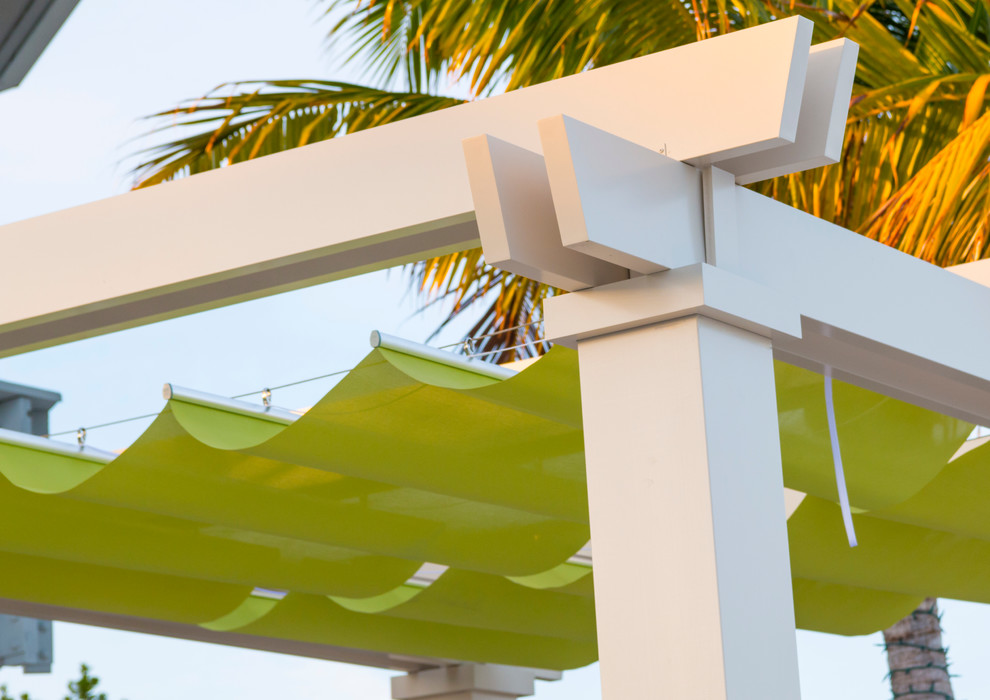 Patio - coastal backyard patio idea in Miami with a pergola