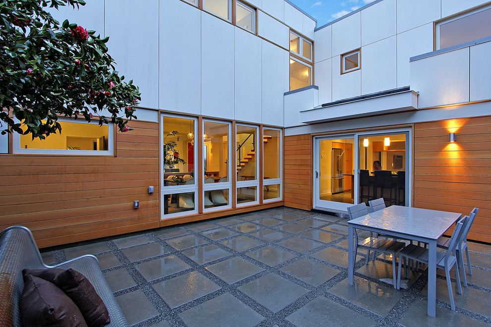Exemple d'une terrasse tendance avec des pavés en béton et aucune couverture.