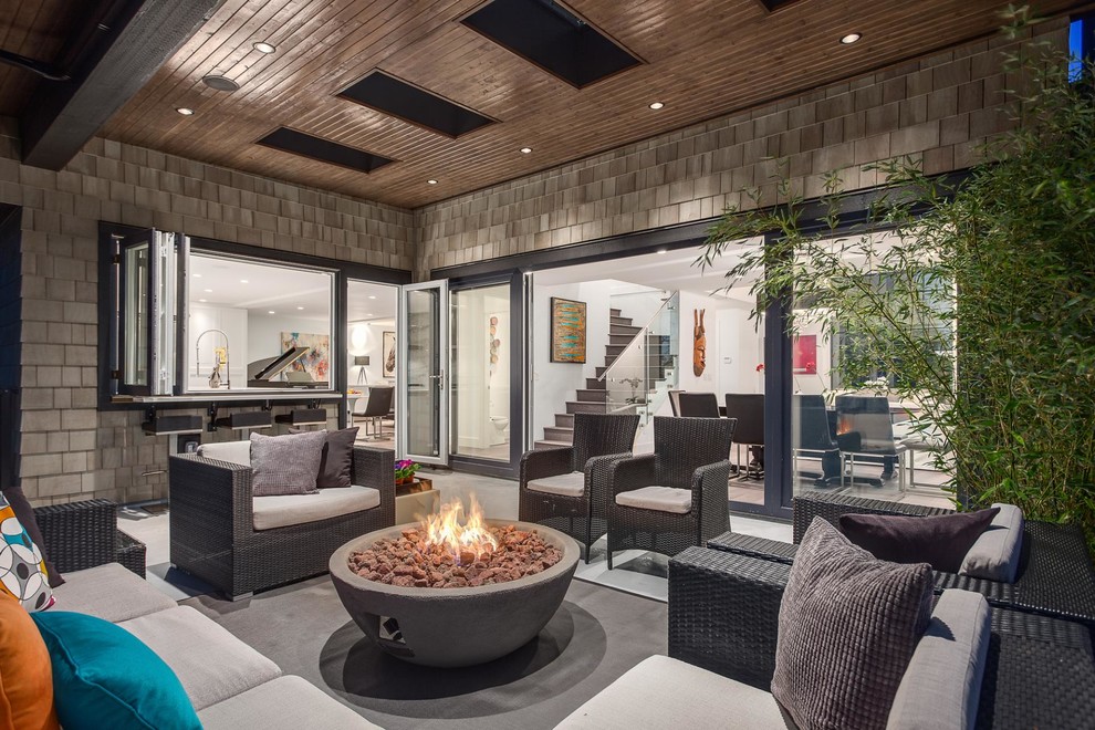 Contemporary patio in Vancouver with a roof extension.