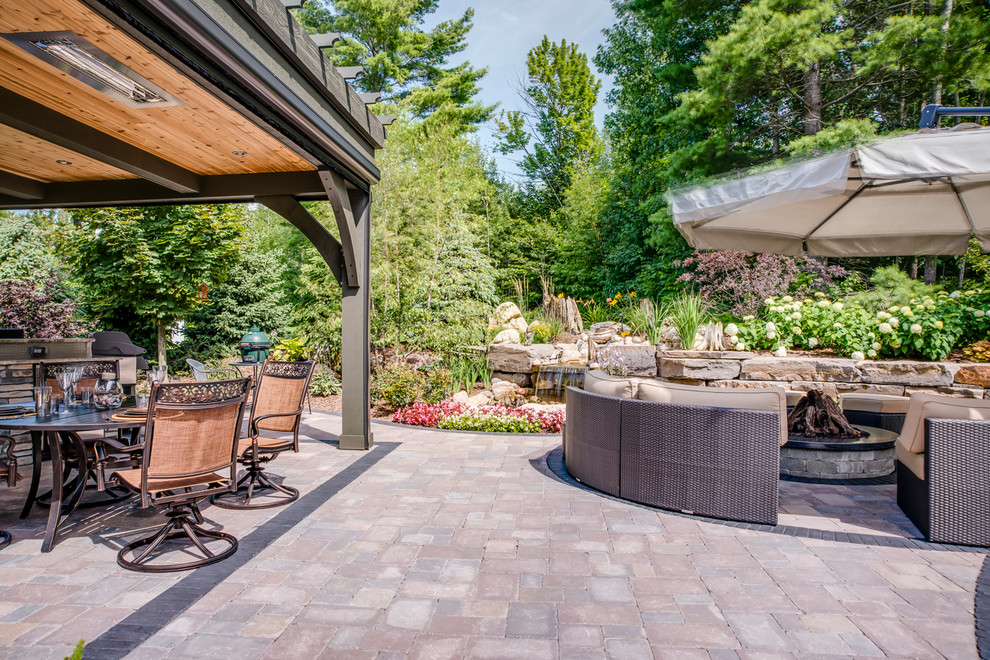 Inspiration for a classic back patio in Other with an outdoor kitchen, brick paving and a gazebo.