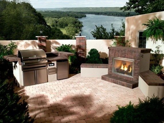 Photo of a traditional back patio in Minneapolis with a fire feature and brick paving.