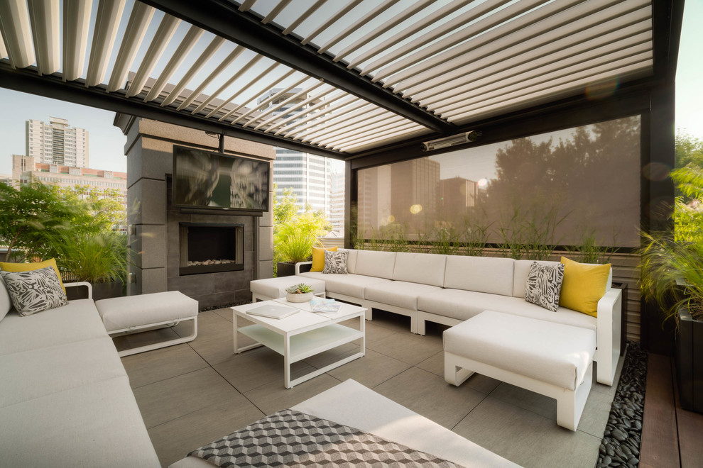 This is an example of a medium sized contemporary patio in Toronto with a living wall, concrete paving and a pergola.