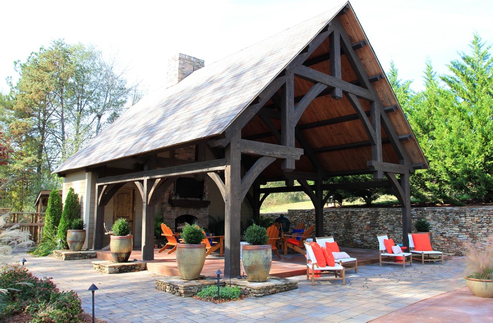 Inspiration for a large timeless backyard stamped concrete patio remodel in Nashville with a fire pit and a pergola