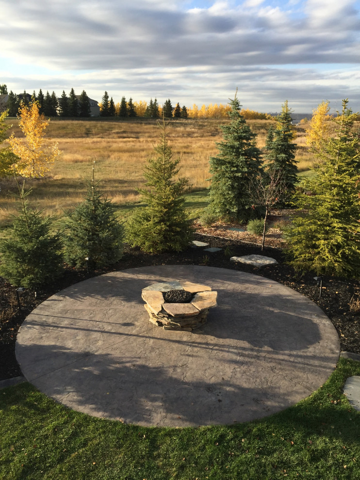 Design ideas for a large classic side patio in Calgary with a fire feature and concrete slabs.