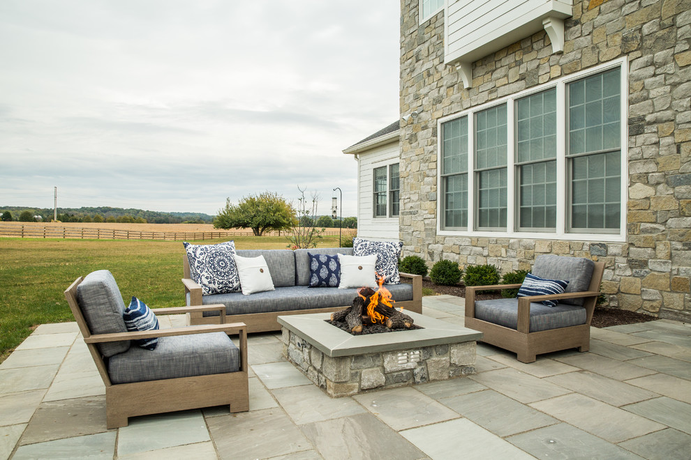 Inspiration for a small contemporary backyard stone patio remodel in Other with a fire pit