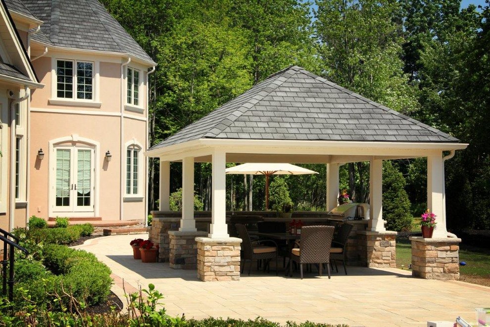 Inspiration for a large transitional backyard concrete paver patio kitchen remodel in Cleveland with a gazebo