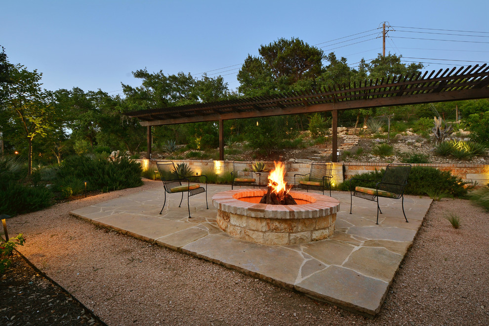 Design ideas for a rustic patio in Austin with a fire feature, natural stone paving and no cover.