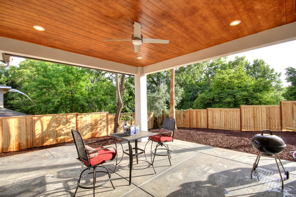 Inspiration for a mid-sized timeless backyard concrete patio remodel in Sacramento with a roof extension