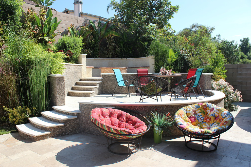 Example of a large trendy backyard tile patio design in Los Angeles with a fire pit and no cover