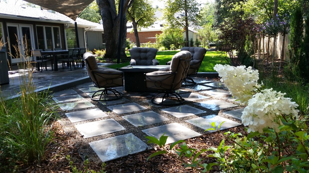 Large traditional back patio in Denver with decomposed granite and an awning.