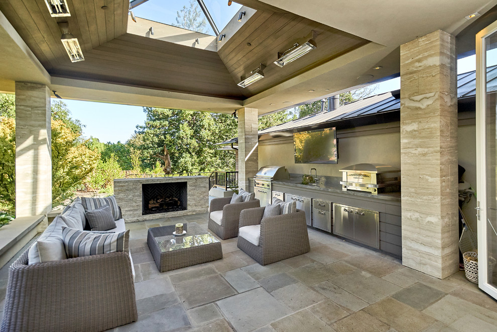 Patio kitchen - large contemporary backyard stone patio kitchen idea in San Francisco with a roof extension