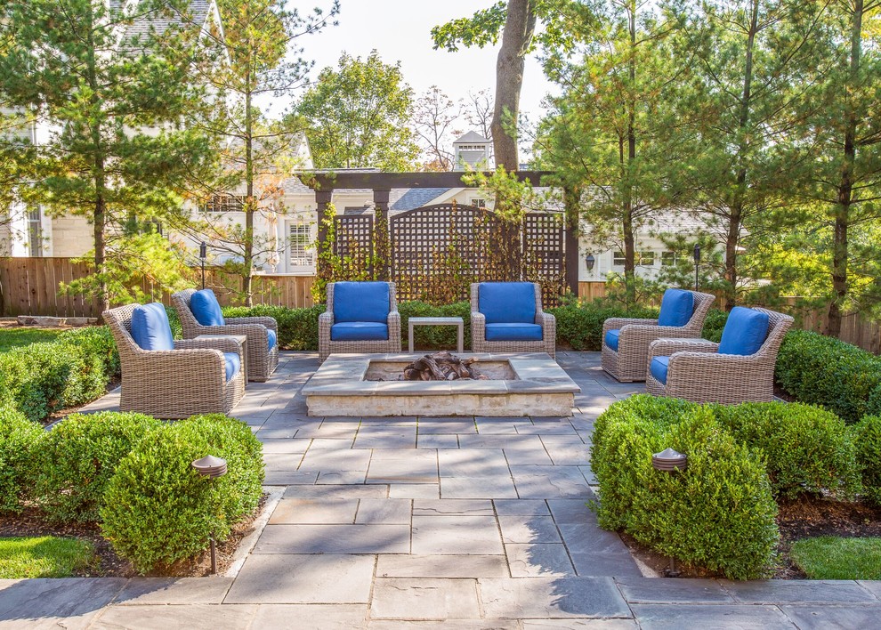 Large transitional backyard stone patio photo in Chicago with a fire pit and a pergola