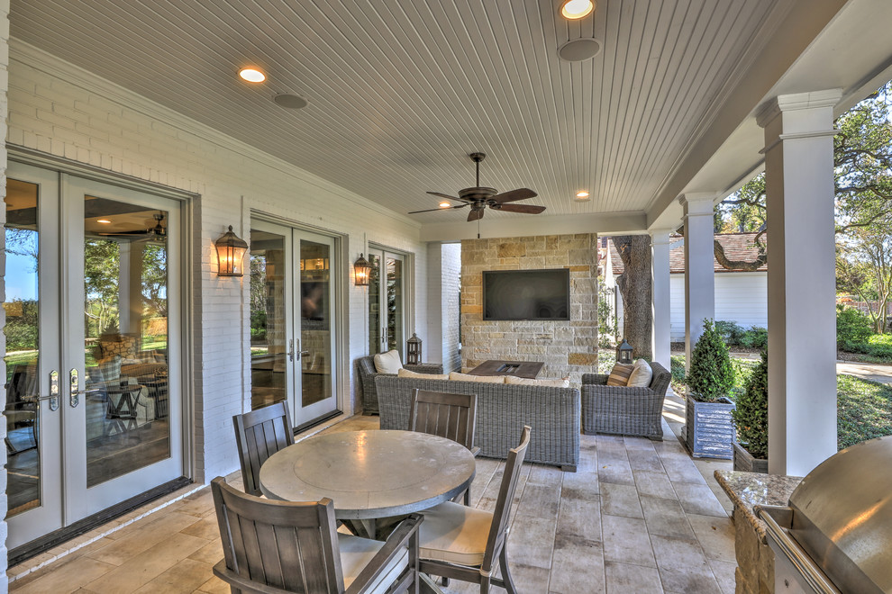 Design ideas for a large traditional back patio in Dallas with an outdoor kitchen, tiled flooring and a roof extension.