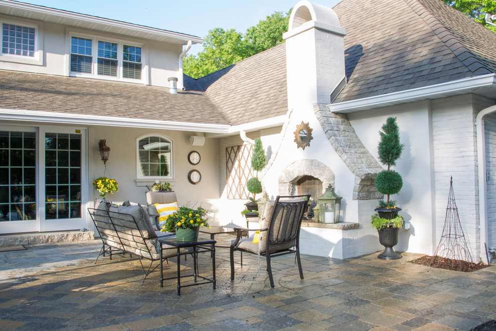 Inspiration for a mid-sized timeless backyard stone patio remodel in Other with a fire pit and no cover