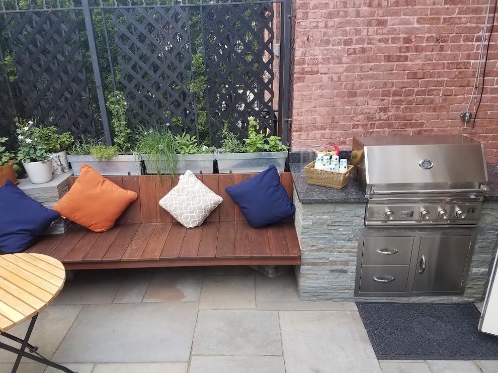 Design ideas for a medium sized contemporary back patio in New York with an outdoor kitchen, tiled flooring and no cover.