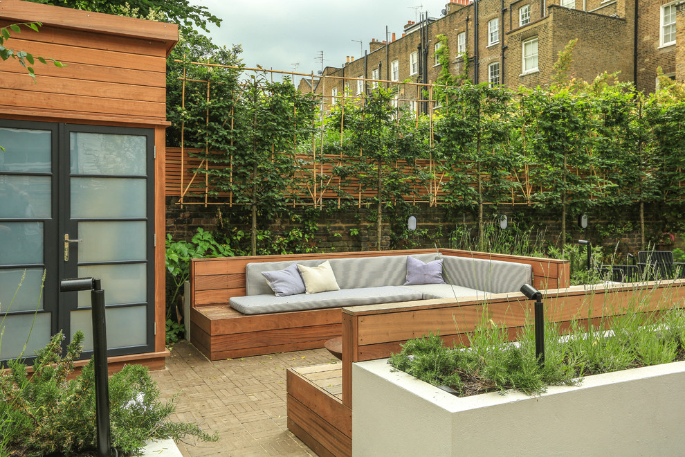 Diseño de patio contemporáneo sin cubierta en patio trasero con adoquines de hormigón