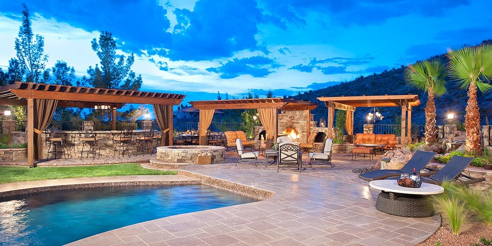 Inspiration for an expansive rustic back patio in Austin with an outdoor kitchen, a pergola and natural stone paving.