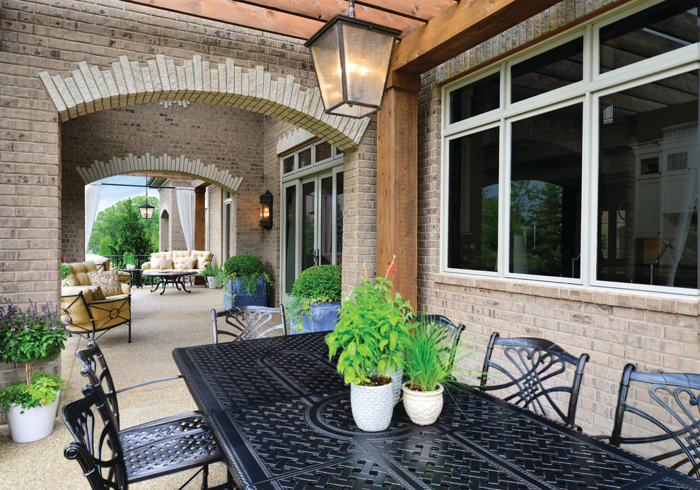 Design ideas for a large mediterranean back patio in Detroit with a pergola.