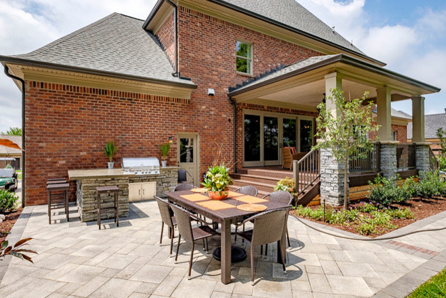 Example of a mid-sized classic backyard concrete paver patio kitchen design in Louisville with no cover