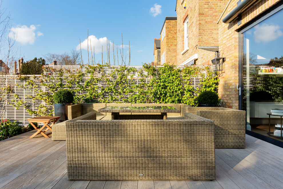 Design ideas for a medium sized traditional back patio in London with decking.