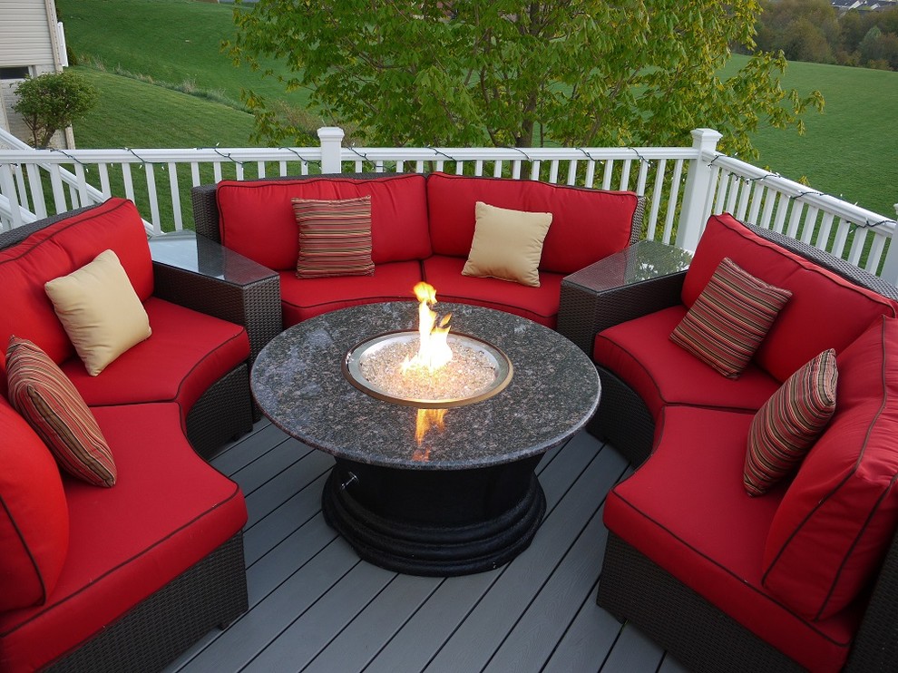 This is an example of a medium sized contemporary back patio in DC Metro with a fire feature, decking and no cover.
