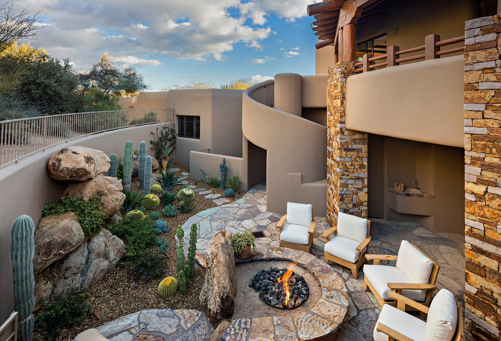 Photo of a back patio in Phoenix with a fire feature and no cover.