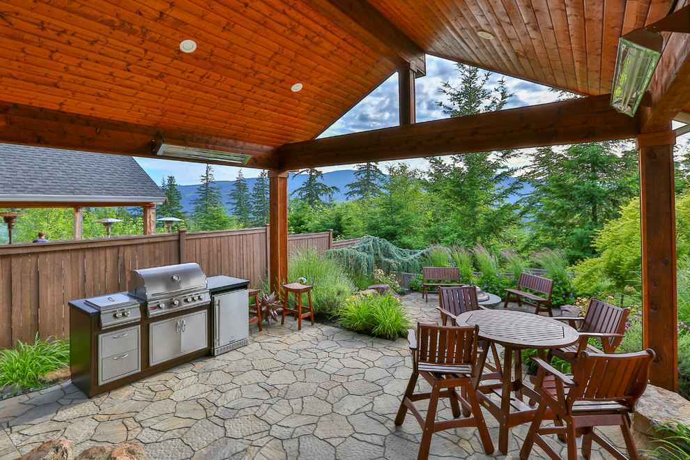 Patio - large craftsman backyard concrete paver patio idea in Seattle with a roof extension
