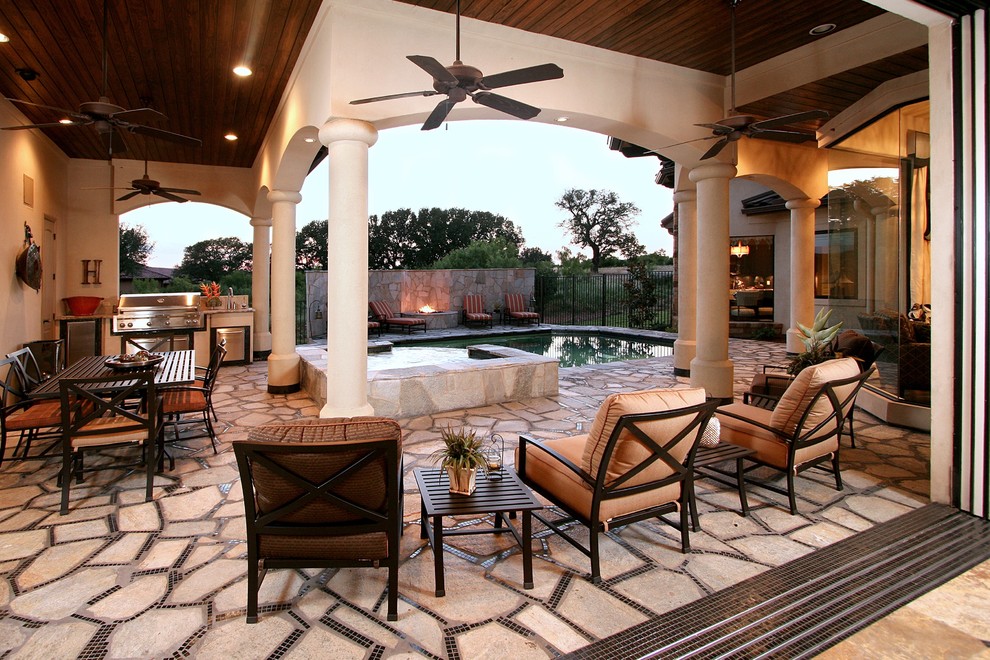 Design ideas for a classic patio in Austin with natural stone paving, a roof extension and a bbq area.