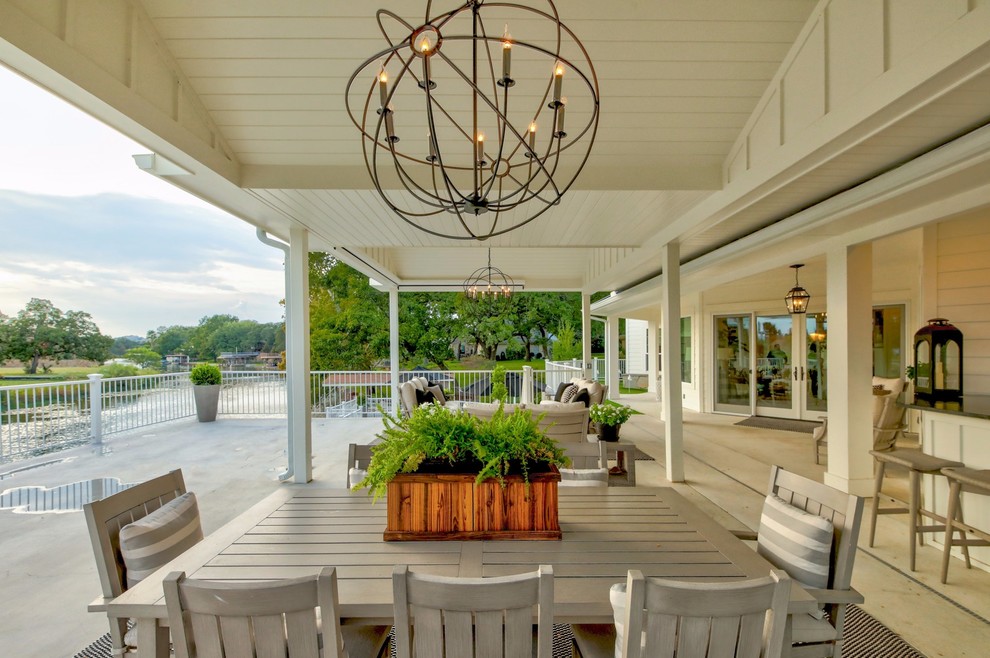 This is an example of a nautical patio in Austin with concrete slabs and a roof extension.