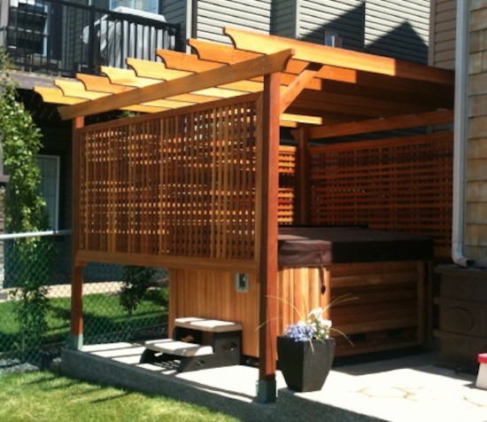 Photo of a back patio in Calgary with a water feature, gravel and a pergola.