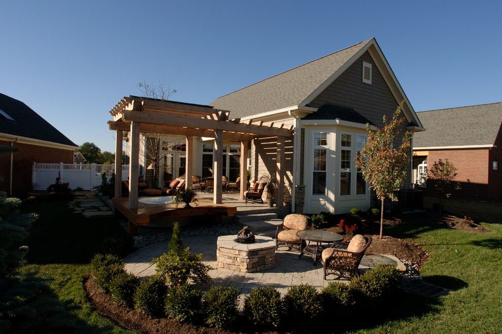 Mid-sized trendy backyard stone patio photo in Philadelphia with a fire pit and a pergola