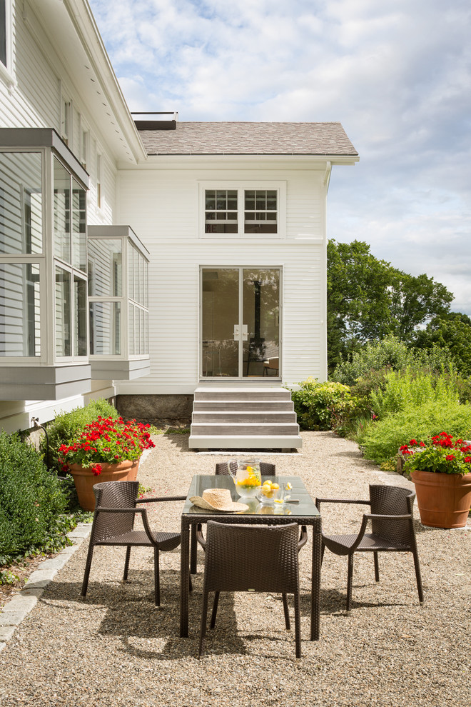 Traditional back patio in Other with a potted garden, gravel and no cover.