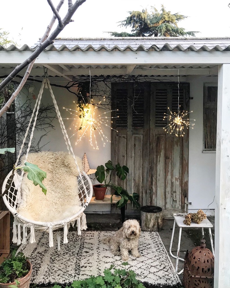 Small cottage chic concrete paver patio photo in Gloucestershire