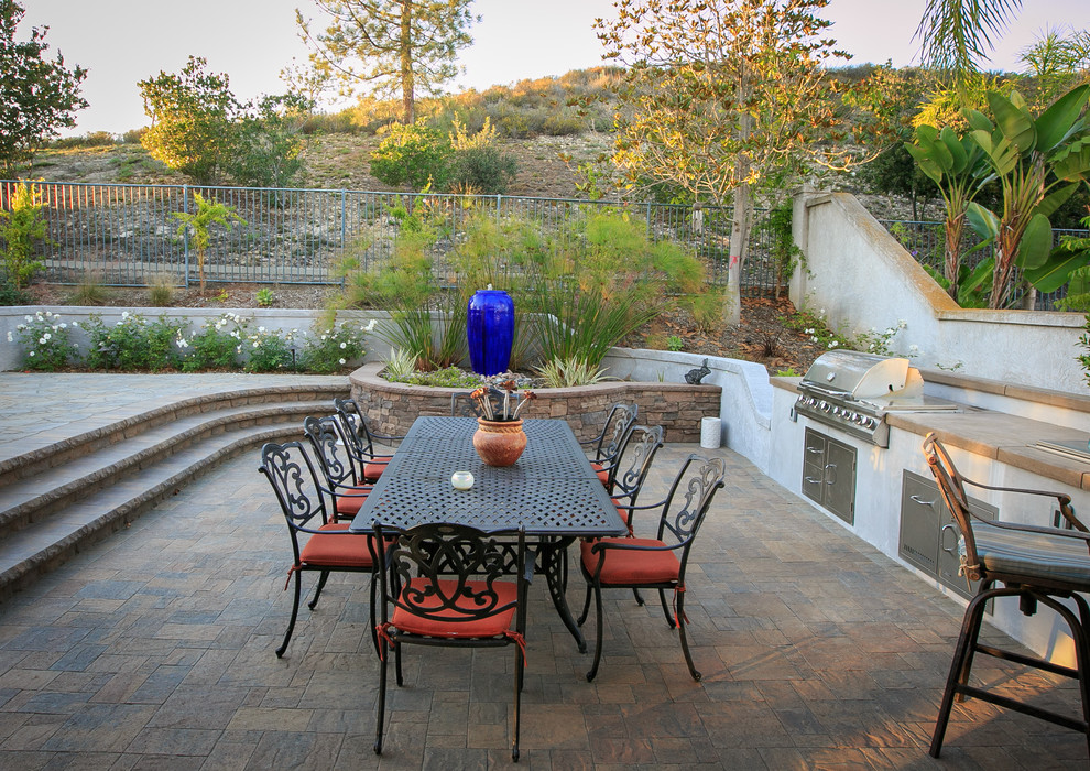 Large elegant backyard concrete paver patio photo in San Diego with a fire pit and a pergola