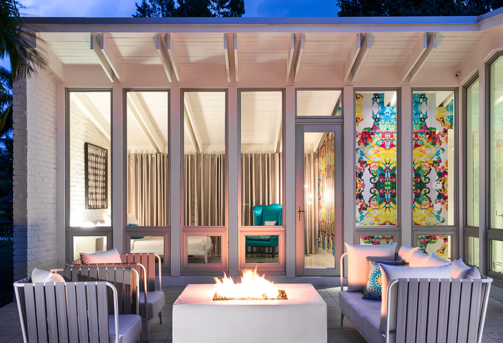 Photo of a retro patio in Miami with a fire feature and no cover.