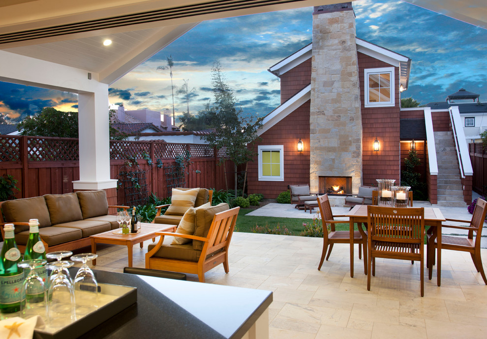 Mid-sized elegant backyard tile patio photo in San Diego with a fire pit and a roof extension