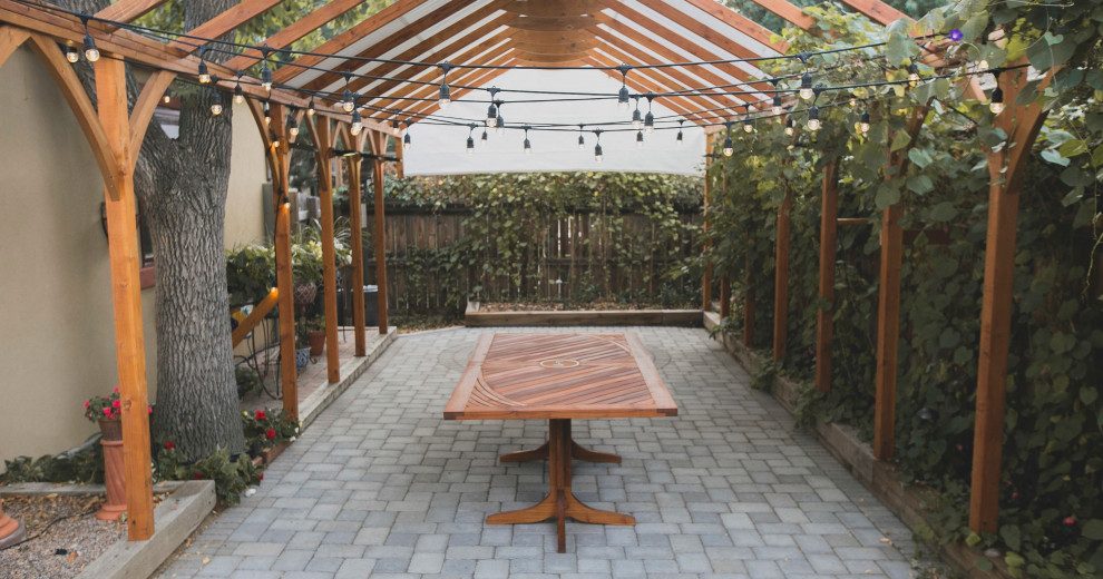 Patio - contemporary backyard concrete paver patio idea in Denver with a pergola