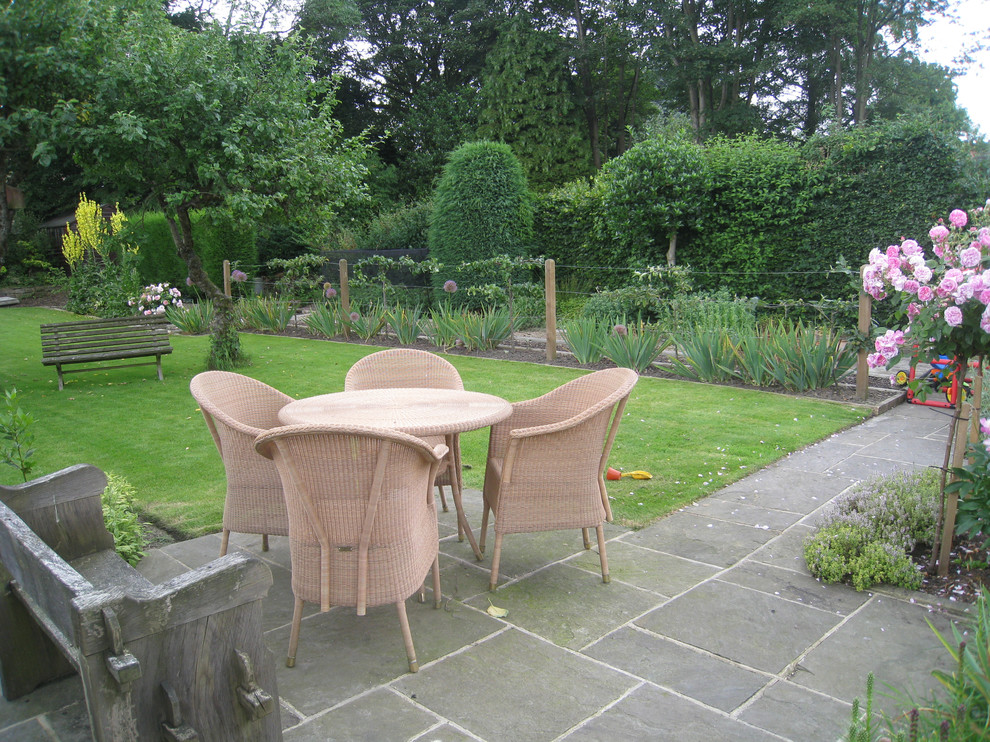 Design ideas for a medium sized contemporary back patio in Cheshire with natural stone paving.