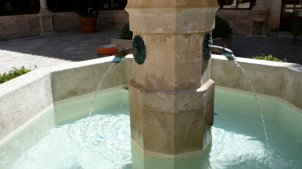 Mid-sized tuscan courtyard stone patio fountain photo in New York with no cover