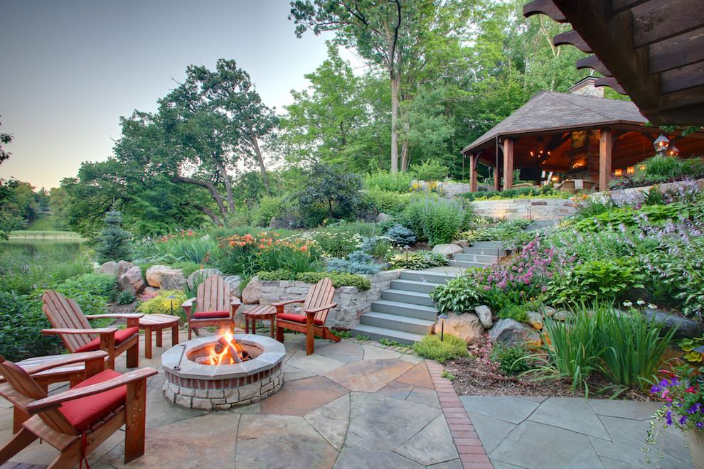 Design ideas for a classic patio in Minneapolis with natural stone paving, a fire feature and no cover.