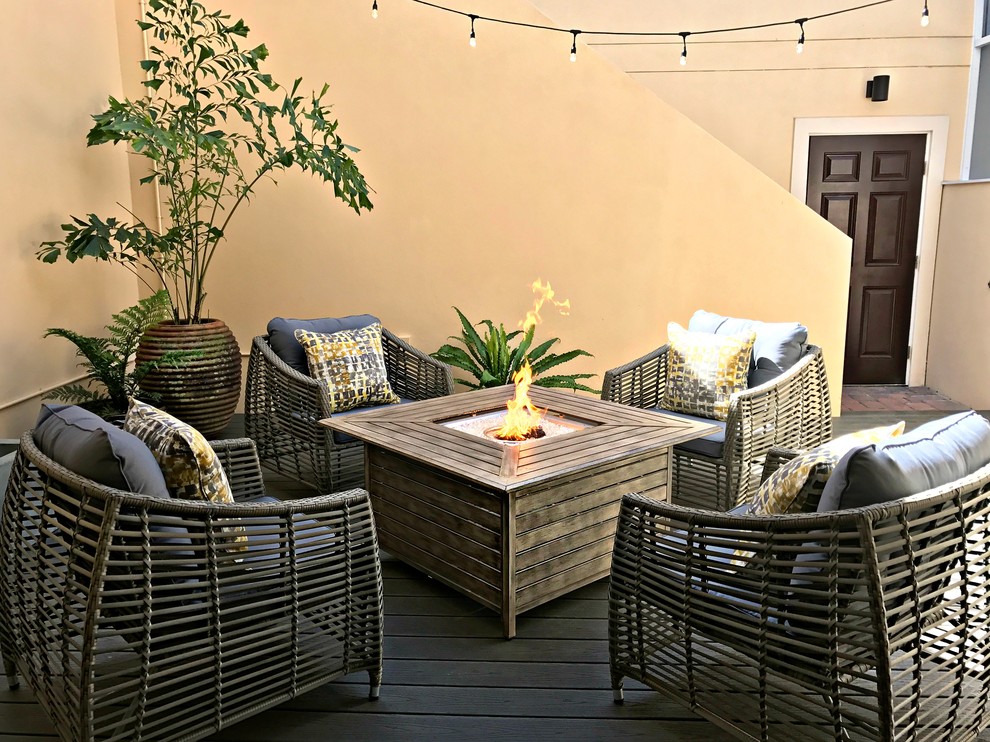 Mid-sized transitional backyard patio photo in Tampa with decking, no cover and a fire pit