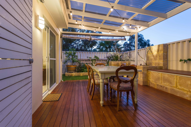 Eclectic courtyard patio photo in Perth with a pergola