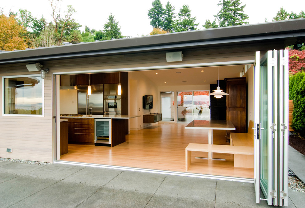 Medium sized contemporary back patio in Seattle with concrete slabs and no cover.